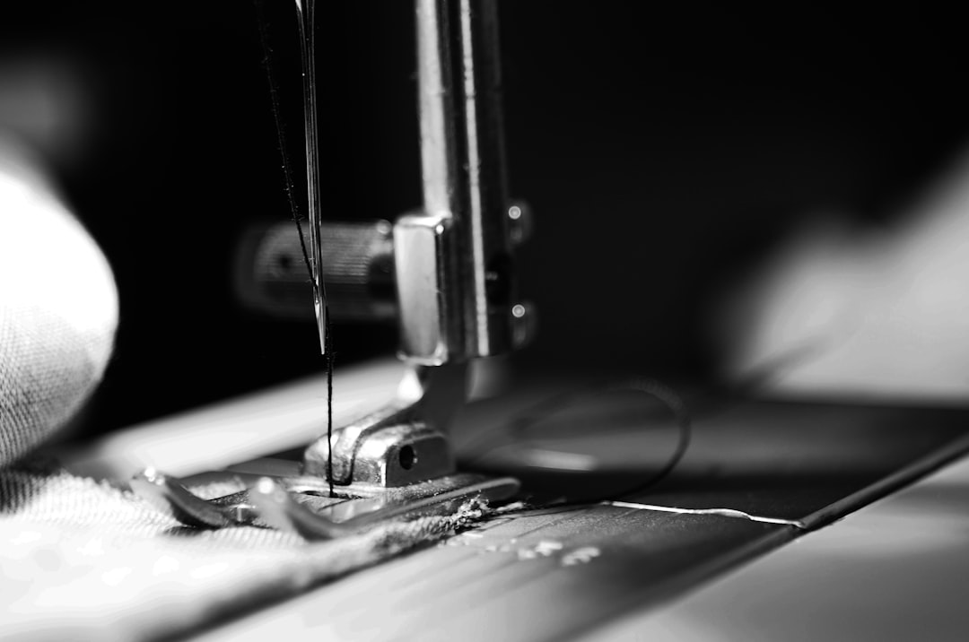 services-01 Black and white image of a sewing machine needle
