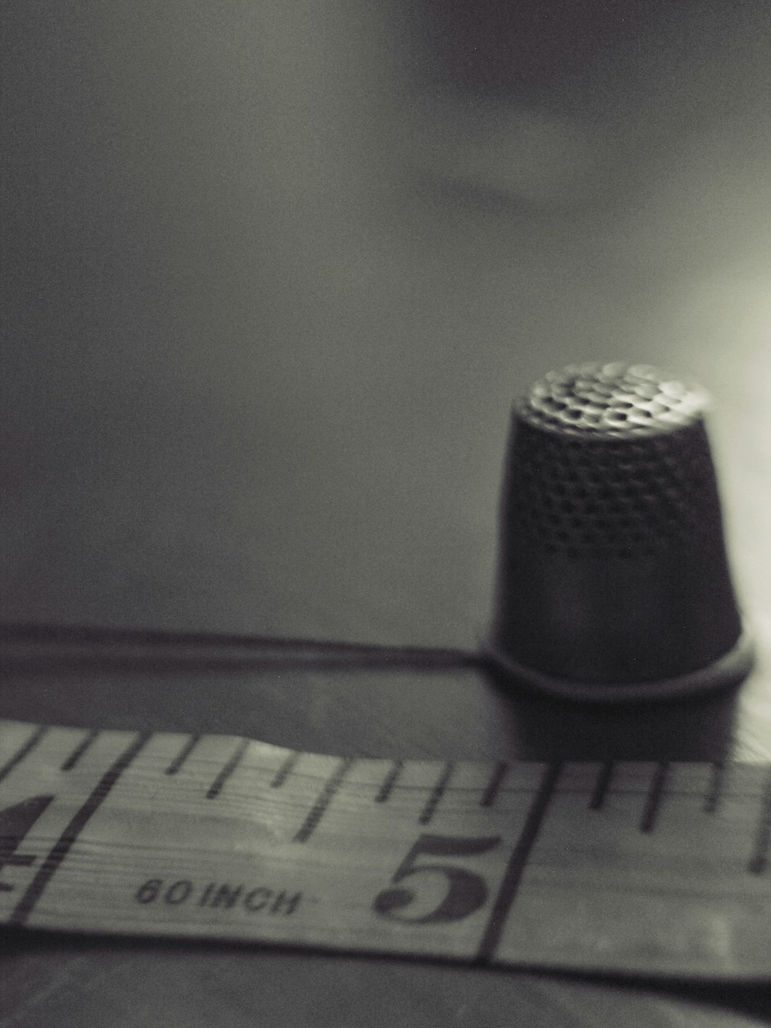 about-us-02 vintage-thimble-and-measuring-tape-in-sepia-tones-zekj7mceaq0